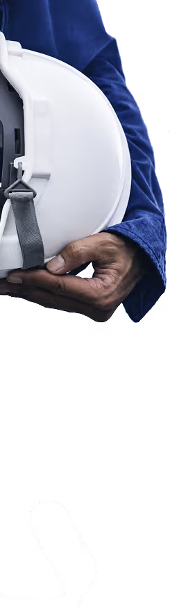 A person in a blue long sleeve shirt holding a white construction hard hat.
